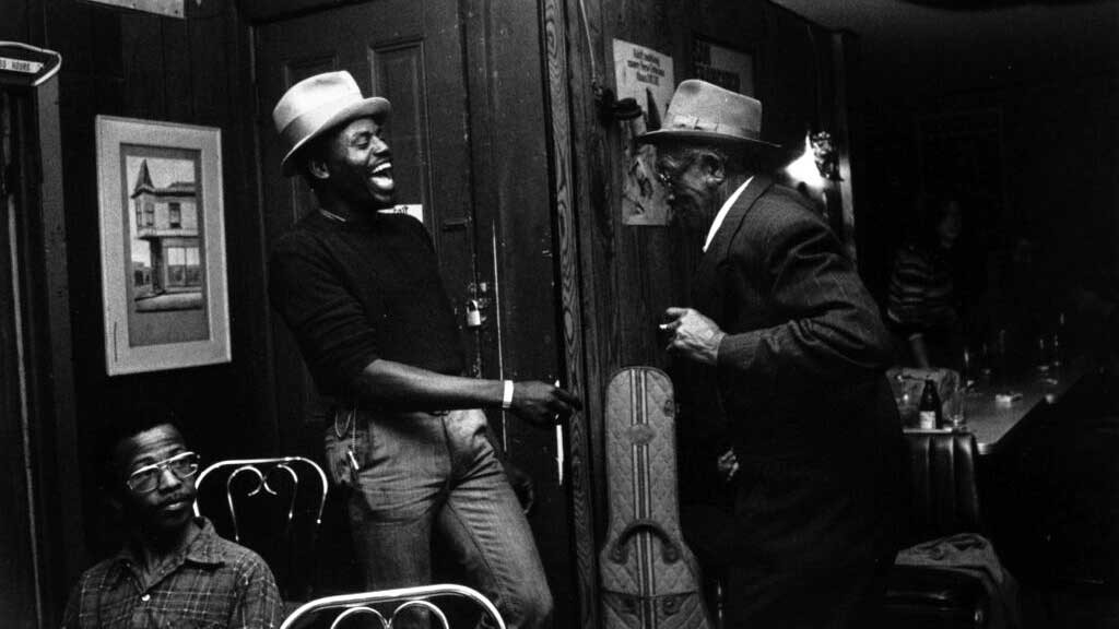 two men laughing in a nightclub