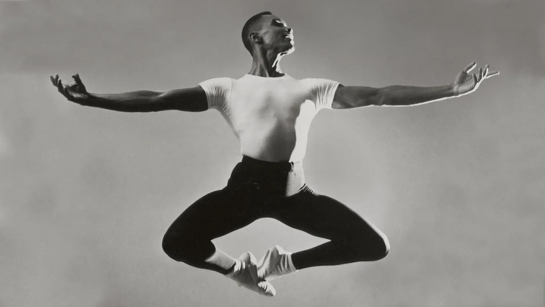 Black and white photo of man dancing - leaping in air