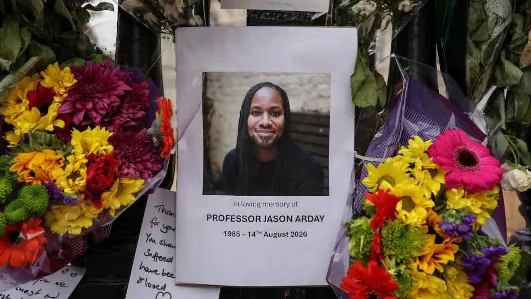 phototraph of a man amongst flowers at a memorial