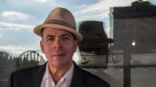 Photo of Steven Gregory wearing a straw hat