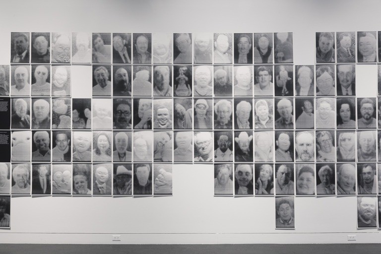 Installation view, Rafael Lozano-Hemmer: A Crack in the Hourglass, An Ongoing COVID-19 Memorial, Brooklyn Museum, October 29, 2021 through June 26, 2022. (Photo: Jonathan Dorado, Brooklyn Museum) Image of black and white photos for art exhibition