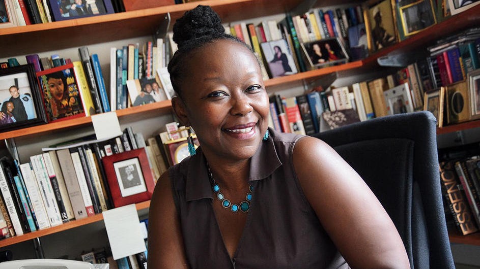 Farah Jasmine Griffin, Chair, African American and African Diaspora Studies department. Photo credit: Eileen Barroso Photo portrait of a woman sitting in front of her library in her office