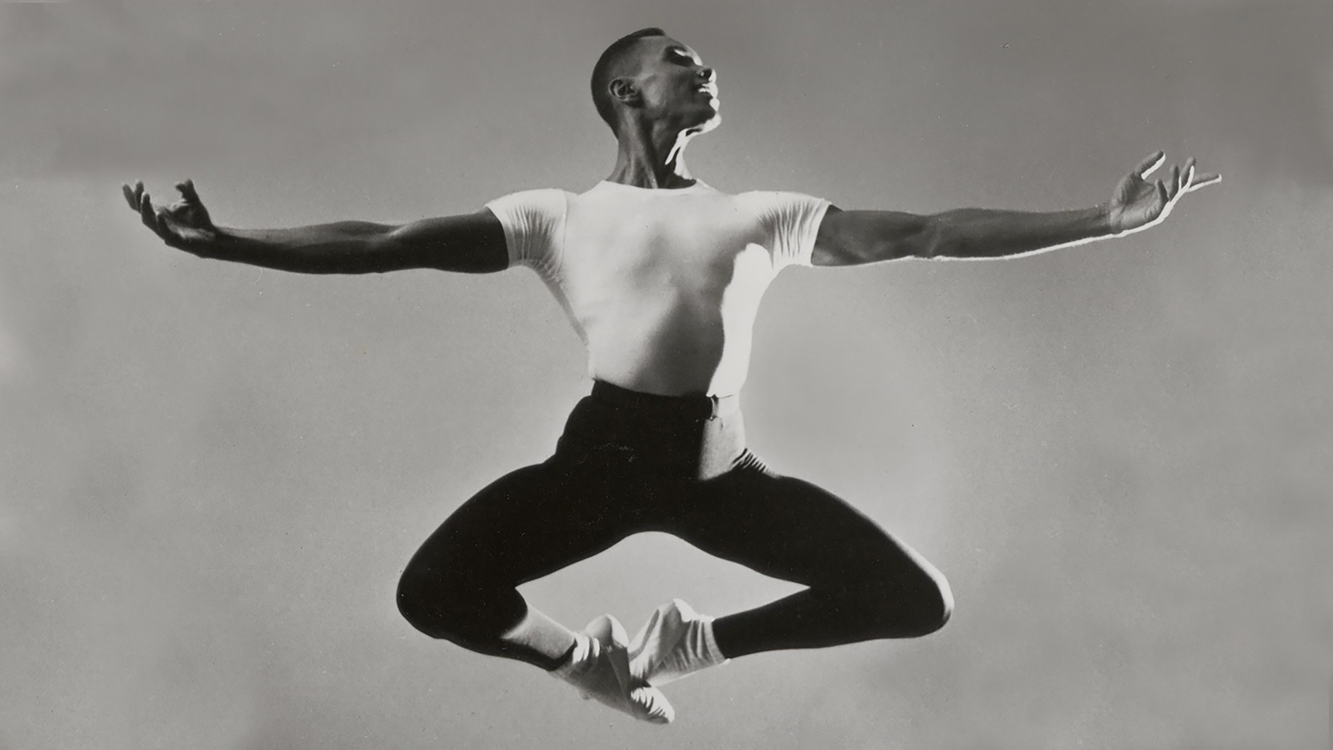 Black and white photo of man dancing - leaping in air